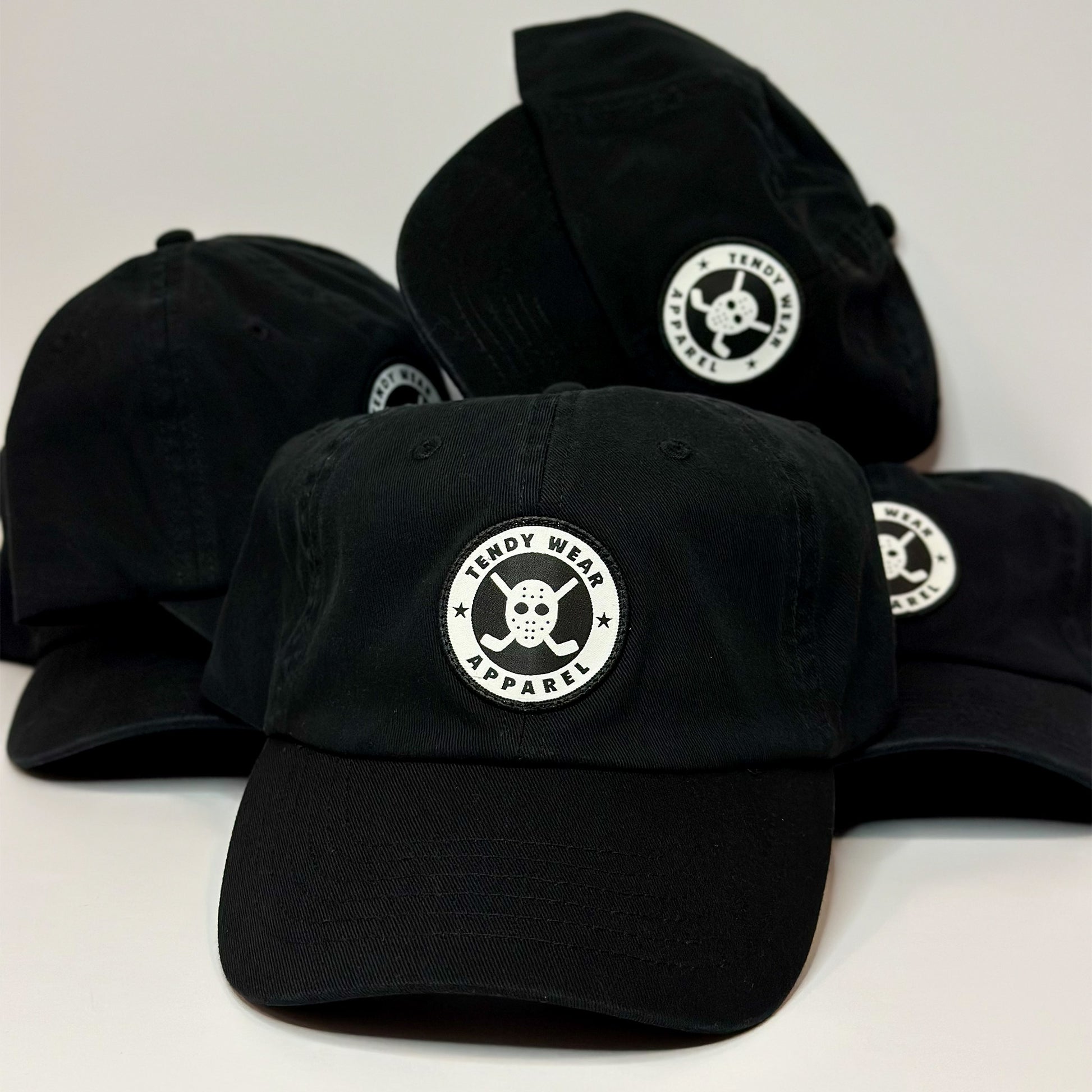 Black caps with a logo on a white background